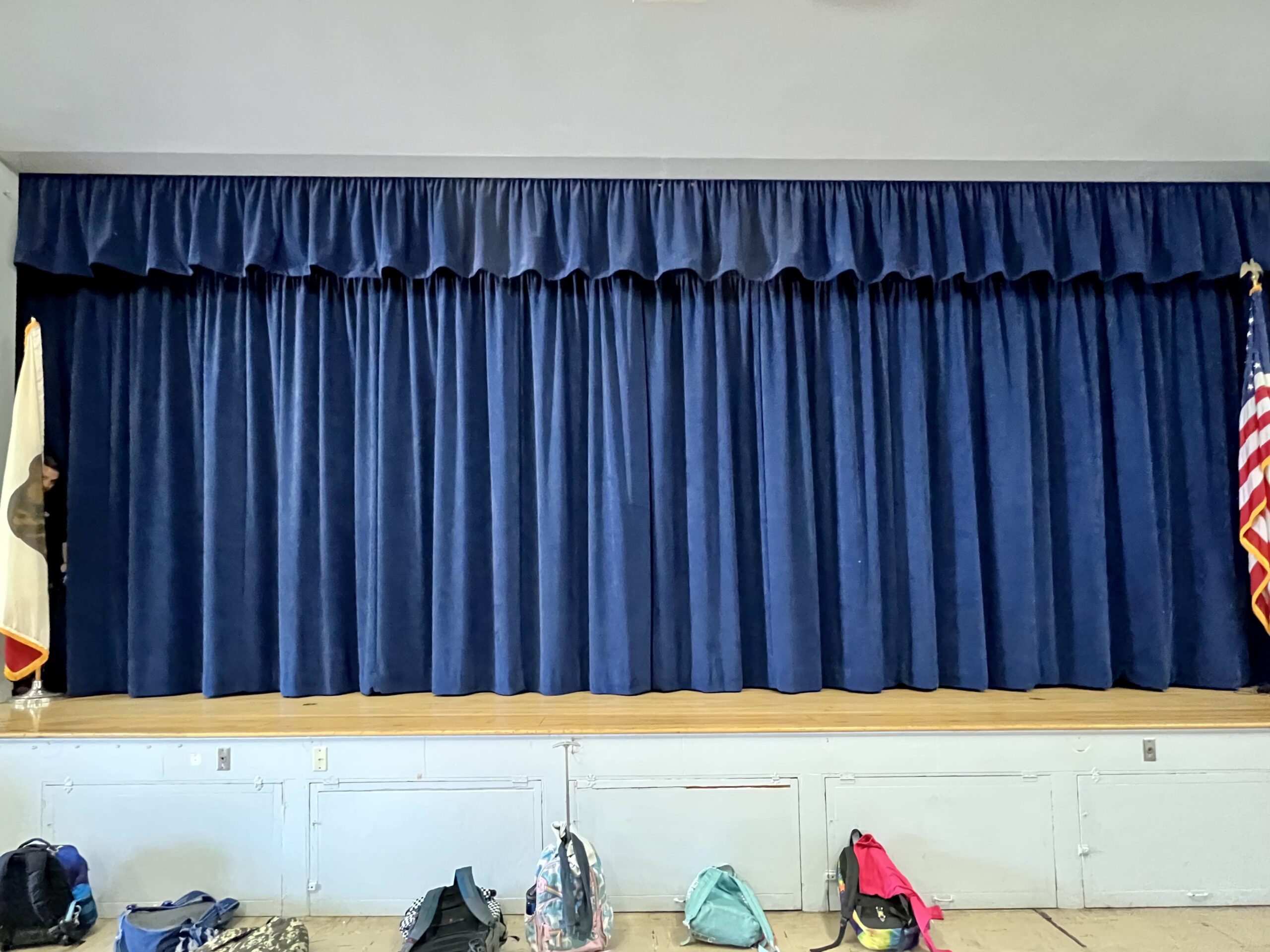 A stage with velvet blue curtains
