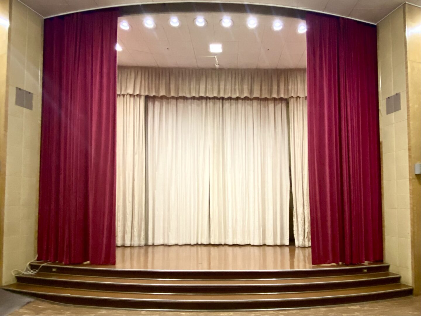 A stage with red and beige curtains